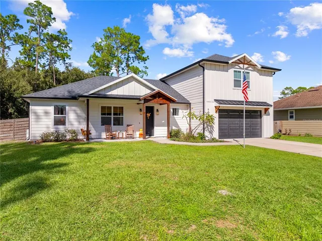 a front view of a house with a garden and porch