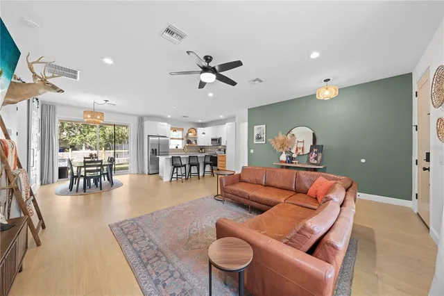 a living room with furniture and wooden floor