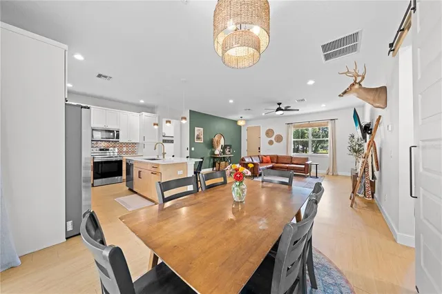 a large kitchen with a table and chairs