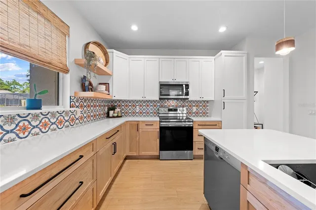 a kitchen with a sink a stove top oven and a refrigerator
