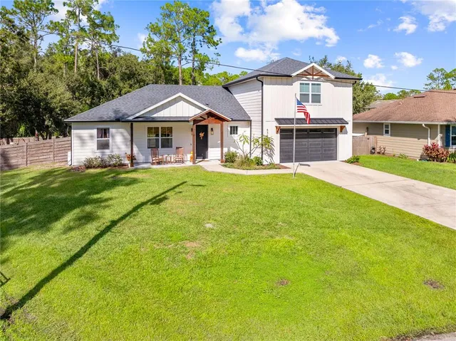 a front view of a house with a garden and deck