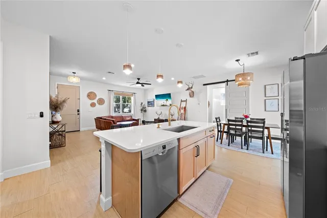 a kitchen with a sink counter top space and stainless steel appliances