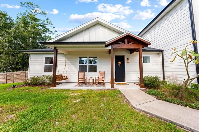 a front view of a house with a yard and porch