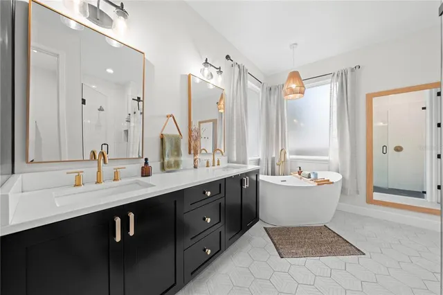 a bathroom with a double vanity sink a large mirror and a shower