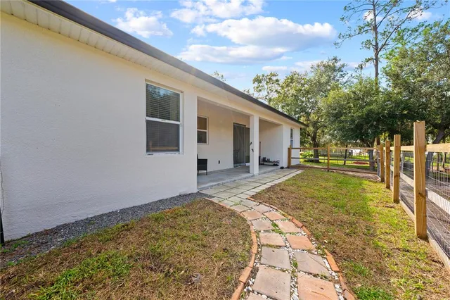 an aerial view of a house with outdoor space