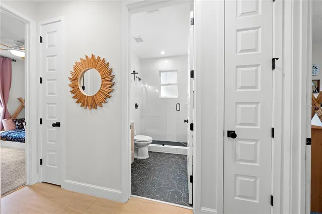 a bathroom with a toilet and a shower