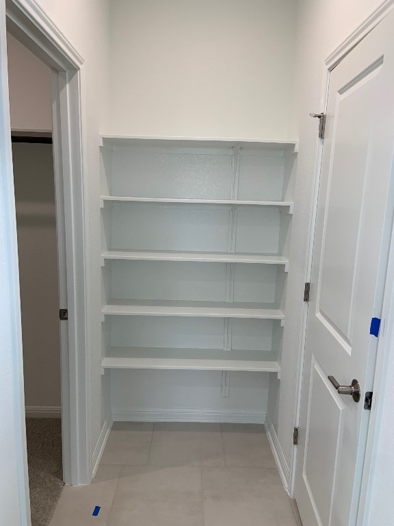 152 Lime Street Buda, TX 78610 - Photo 20 of 32 a view of walk in closet with empty racks