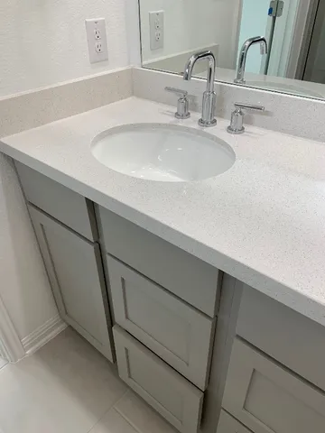a bathroom with a sink toilet and a mirror
