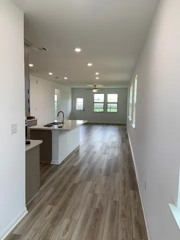 a view of kitchen with sink and wooden floor