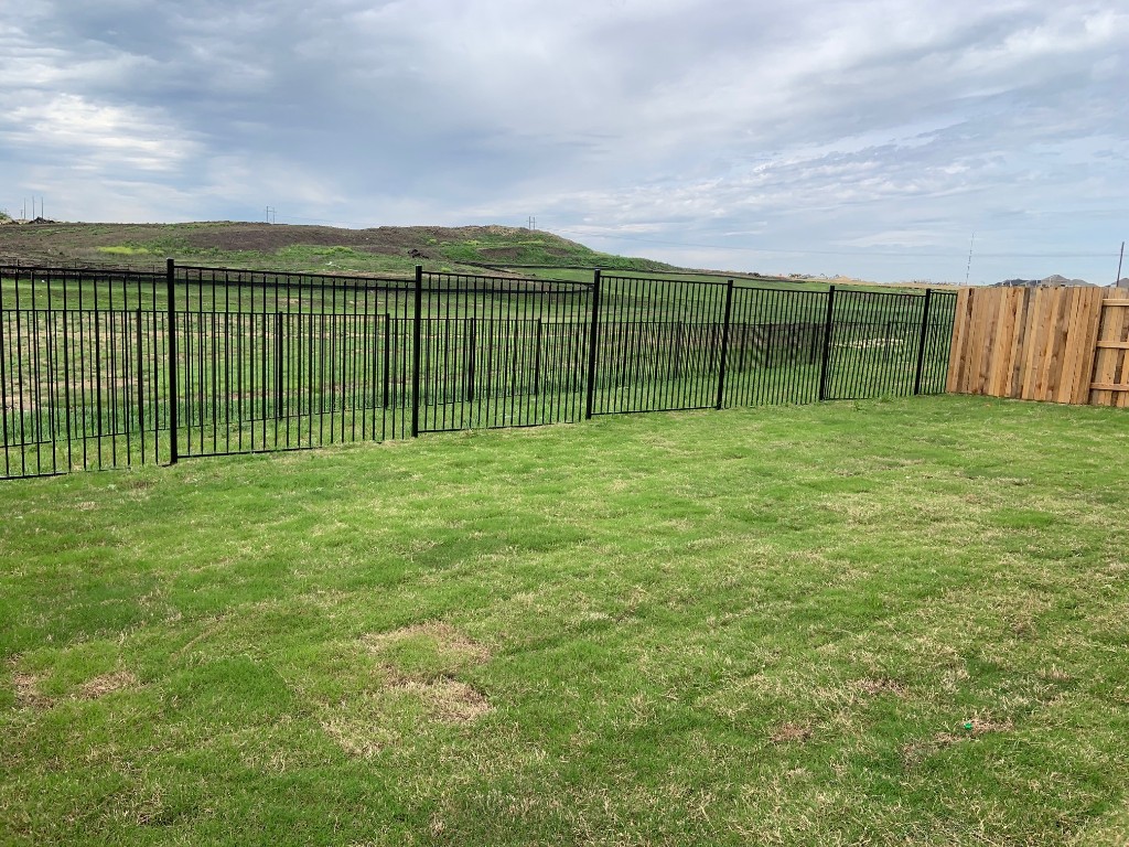 152 Lime Street Buda, TX 78610 - Photo 10 of 32 a view of green field with wooden fence