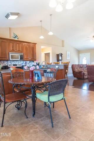 a living room with furniture a table and chairs