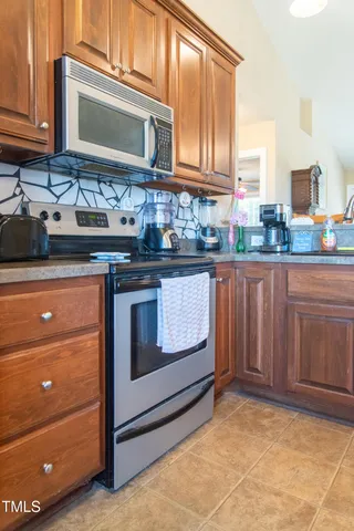 a kitchen with granite countertop cabinets stainless steel appliances and a sink