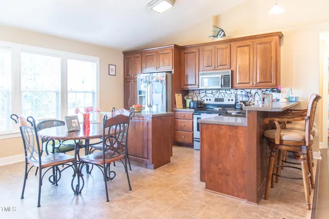 a view of a dining room with furniture window and outside view