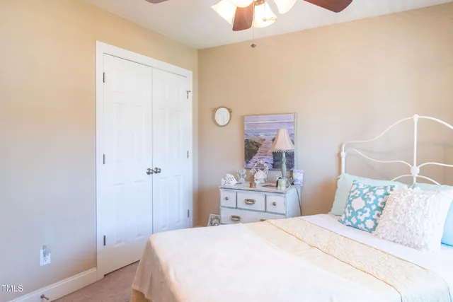 a bedroom with a bed and a dresser