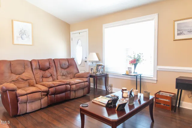 a living room with furniture and wooden floor