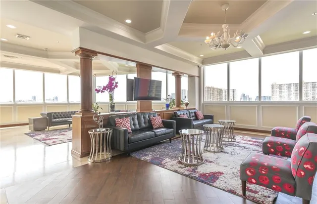 a living room filled with furniture and a floor to ceiling window