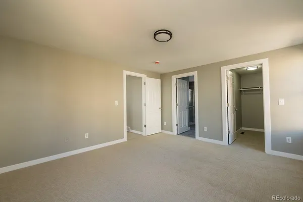 a view of an empty room with closet area