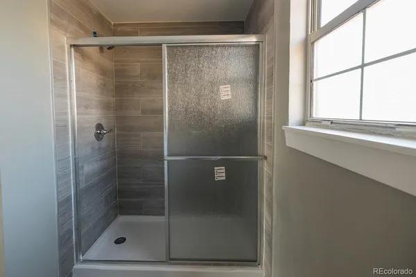 a bathroom with a glass shower door