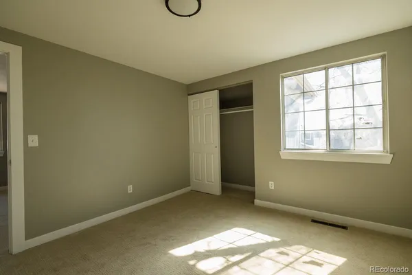 a view of a room with wooden floor and window