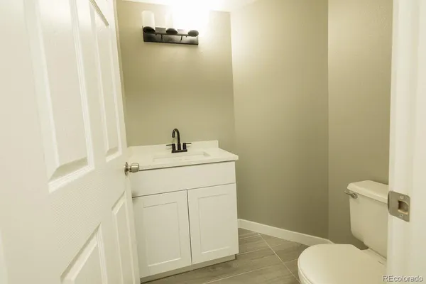 a bathroom with a sink toilet and vanity