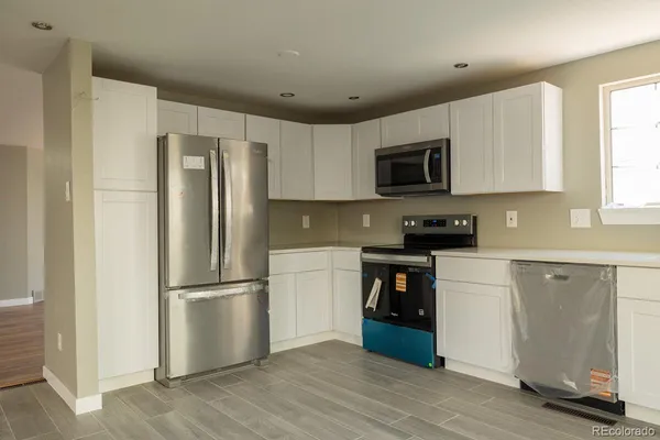 a kitchen with a refrigerator stove and microwave