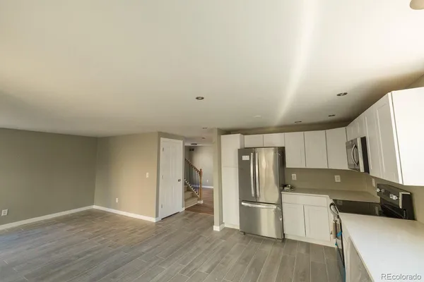 a kitchen with a refrigerator sink and microwave