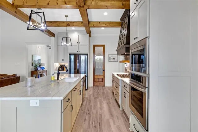 a kitchen with stainless steel appliances granite countertop a refrigerator and a stove