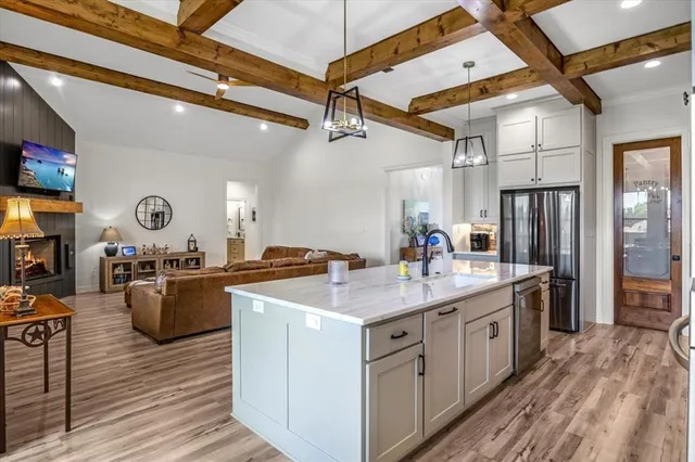 a kitchen with a stove a refrigerator and wooden cabinets