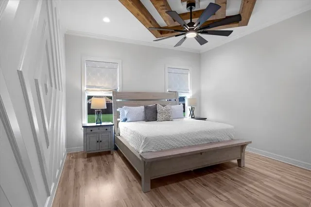a bedroom with a bed and a ceiling fan
