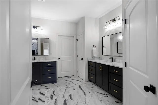 a bathroom with a sink vanity and mirror