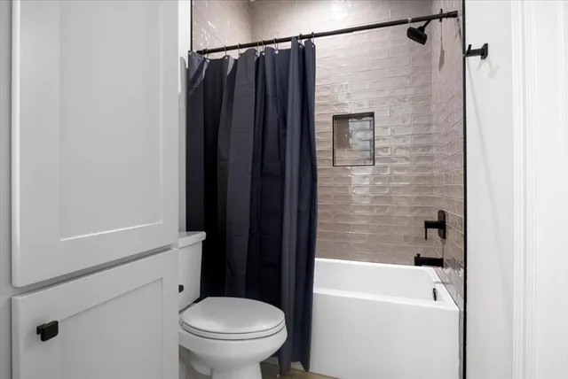 a bathroom with a shower and a toilet