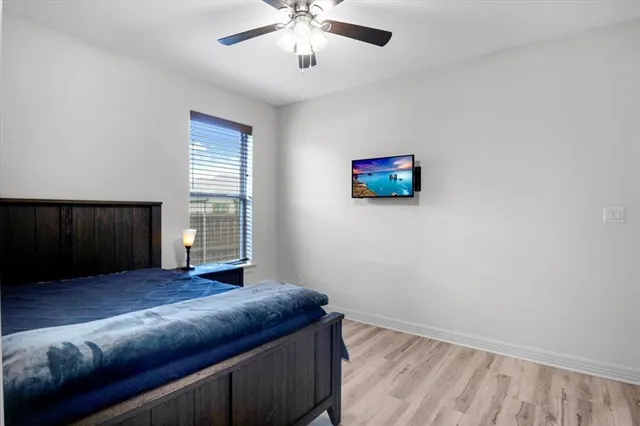 a bedroom with a bed and a window