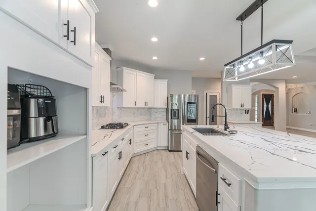 a kitchen with a stove a refrigerator and a sink