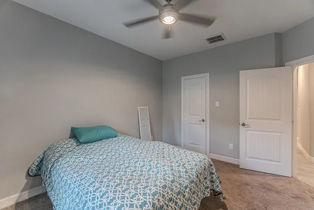 a bedroom with bed and a window