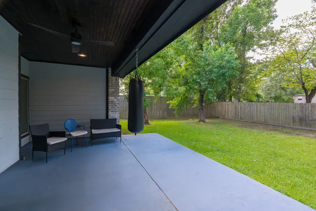 a view of a backyard with a garden and entertaining space