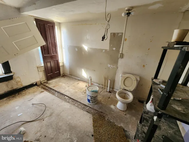 a view of a room with furniture and wooden floor