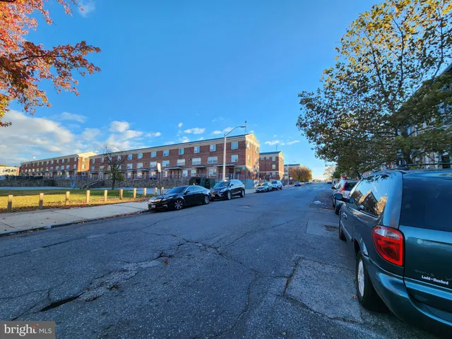 a view of a swimming pool with a lounge chair and back yard of the house