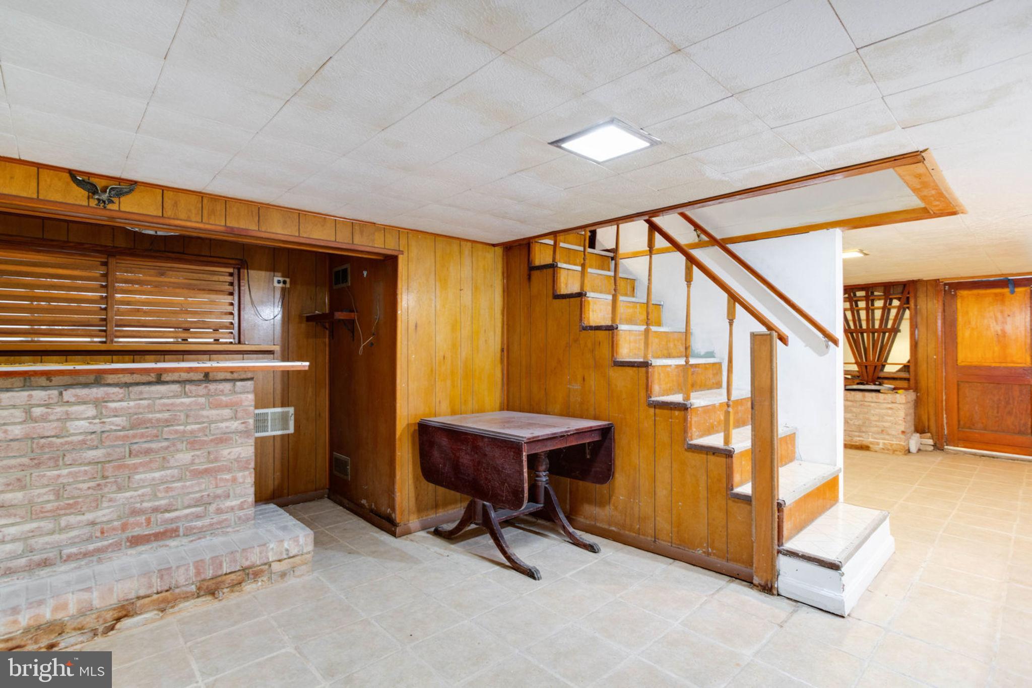 7841 Clark Station Road Severn, MD 21144 - Photo 28 of 46 Basement with Bar and Staircase leading Upstairs
