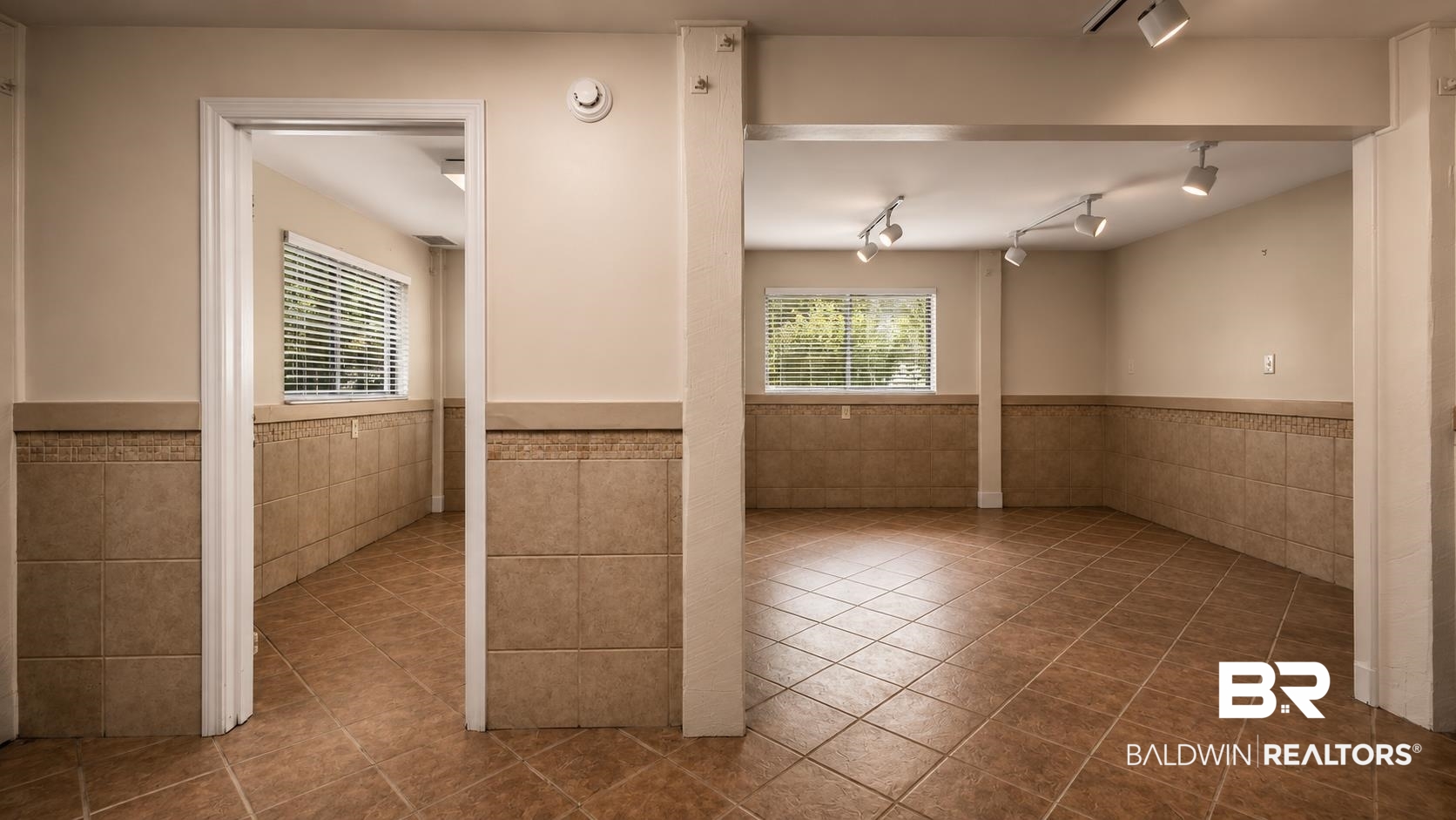 14587 Ridge Road Summerdale, AL 36580 - Photo 33 of 44 Expansive tiled flooring throughout, complemented by a partial tiled wall treatment