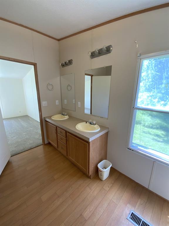 929 Neighbors Corner Road Mart, TX 76664 - Photo 15 of 28 a bathroom with a granite countertop sink mirror and a window