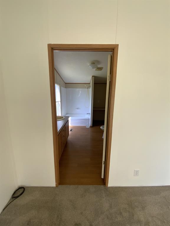 929 Neighbors Corner Road Mart, TX 76664 - Photo 16 of 28 a view of a hallway with wooden floor
