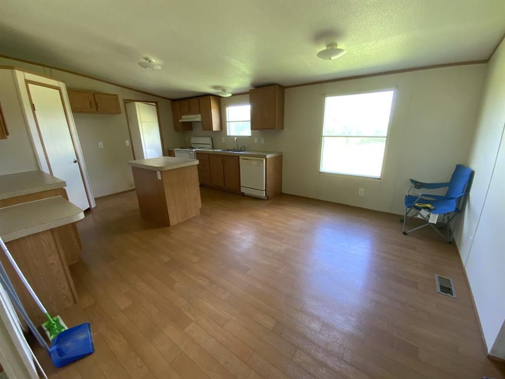 929 Neighbors Corner Road Mart, TX 76664 - Photo 5 of 28 a view of an empty room with a window and wooden floor