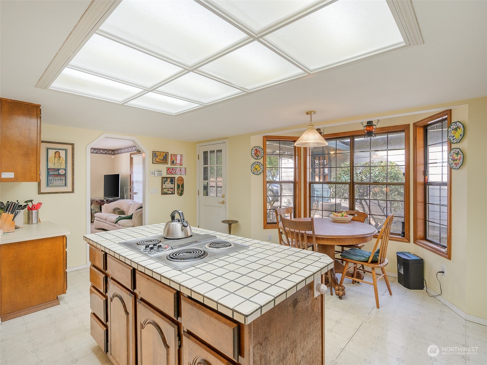 5814 Northwest 169th Street Ridgefield, WA 98642 - Photo 11 of 40 a dining room with a table chairs and a kitchen view