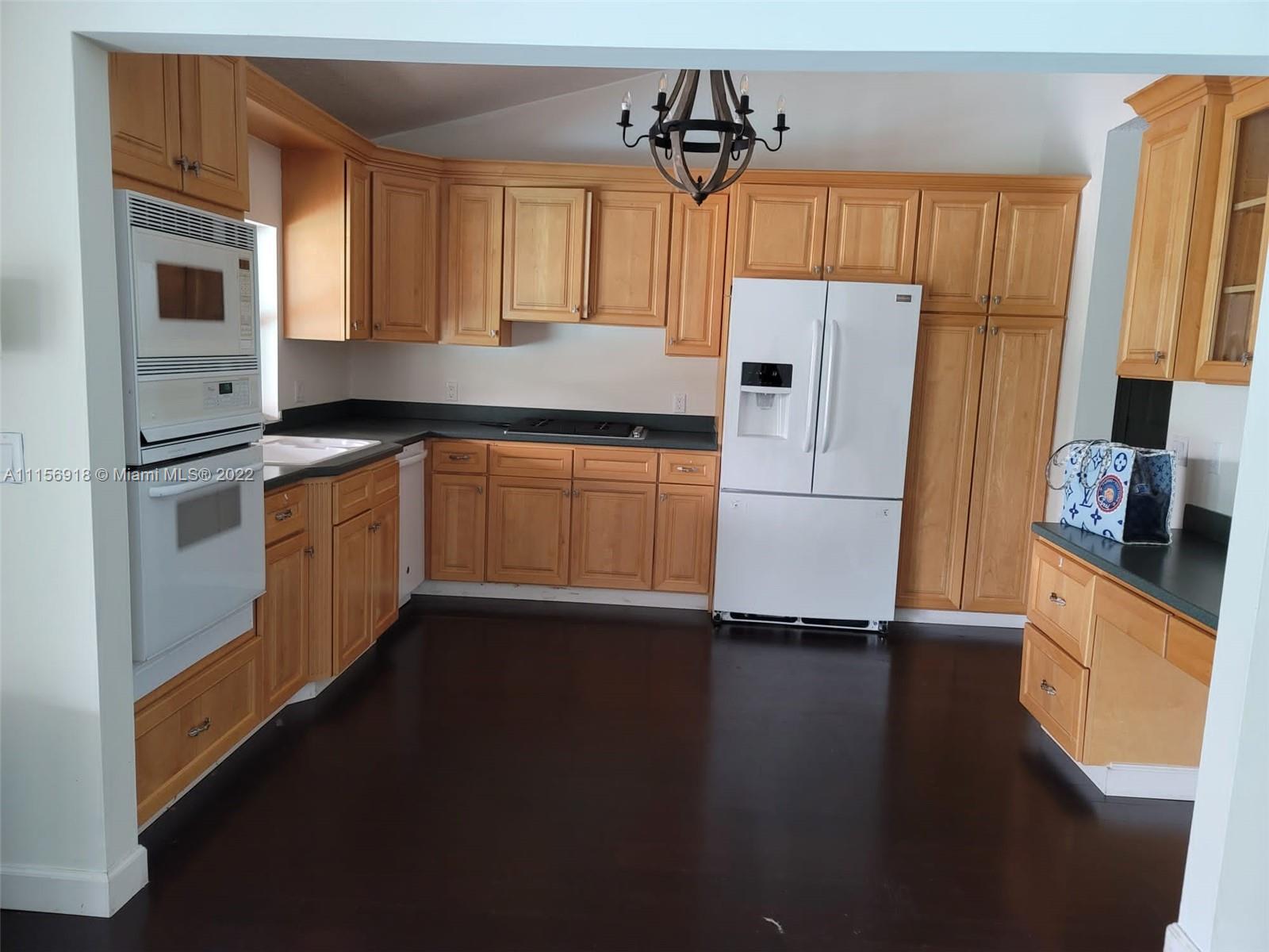 8425 Southwest 185th Street Cutler Bay, FL 33157 - Photo 11 of 17 a kitchen with stainless steel appliances a refrigerator sink and microwave