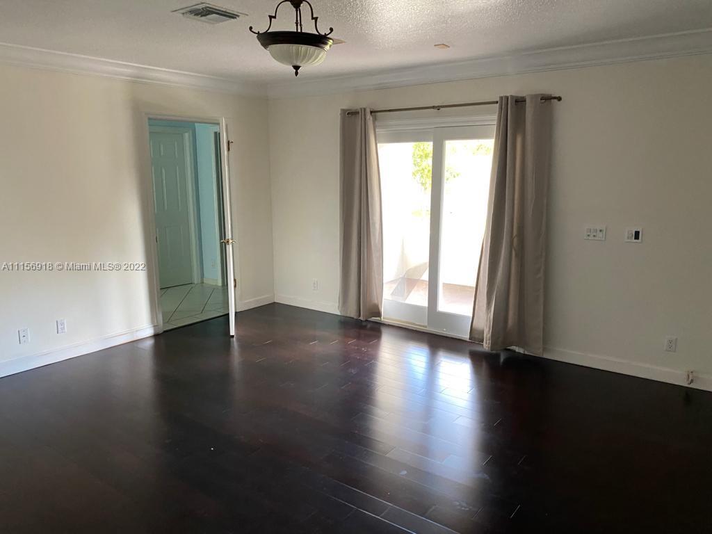 8425 Southwest 185th Street Cutler Bay, FL 33157 - Photo 13 of 17 an empty room with wooden floor and windows