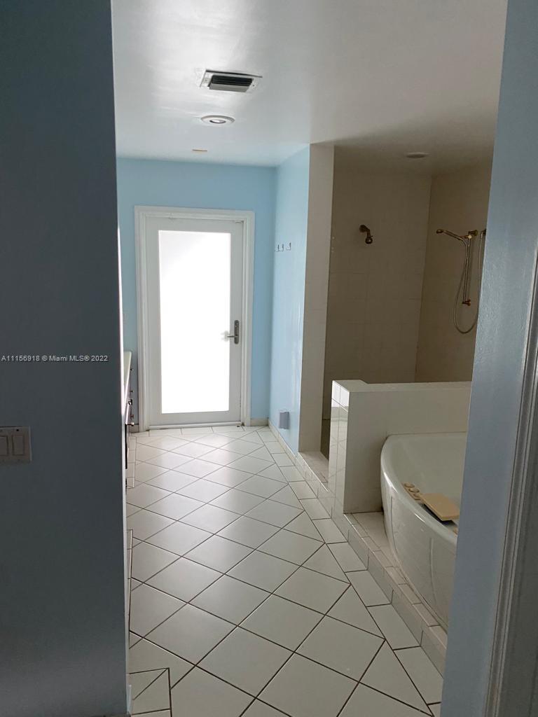 8425 Southwest 185th Street Cutler Bay, FL 33157 - Photo 14 of 17 a bathroom with a bathtub and a toilet