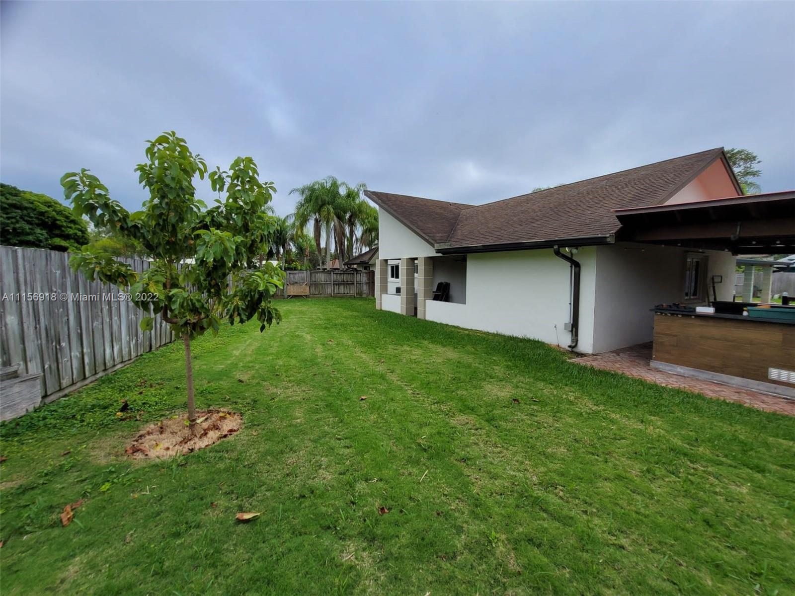 8425 Southwest 185th Street Cutler Bay, FL 33157 - Photo 6 of 17 a front view of a house with a garden