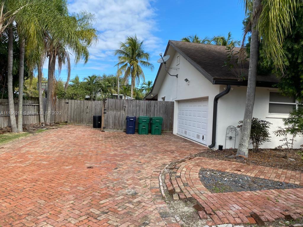 8425 Southwest 185th Street Cutler Bay, FL 33157 - Photo 7 of 17 a backyard of a house with palm trees
