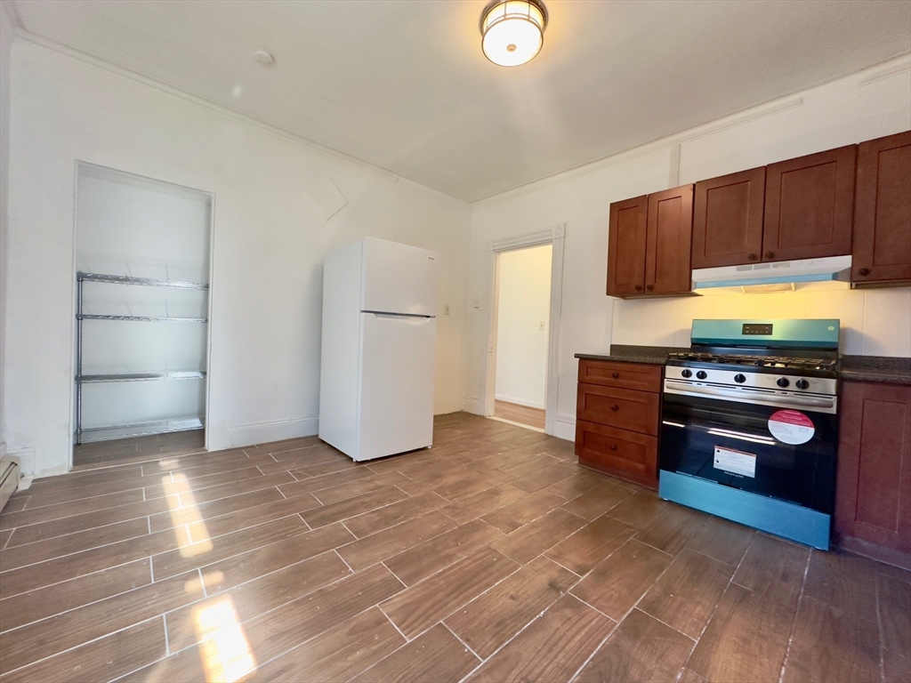 a kitchen with stainless steel appliances granite countertop a stove and a refrigerator