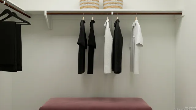 a view of walk in closet with clothes